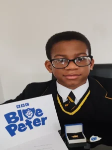 Jayce Joyce BCyA holding his BBC Blue Peter Gold Badge — December 2025